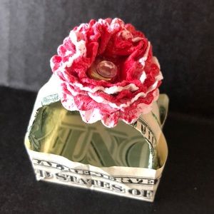 Origami basket handmade from dollar bill, accented with red and white flower